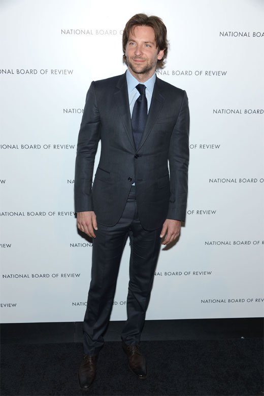 Bradley Cooper cuts a dashing figure in navy suit as he models a