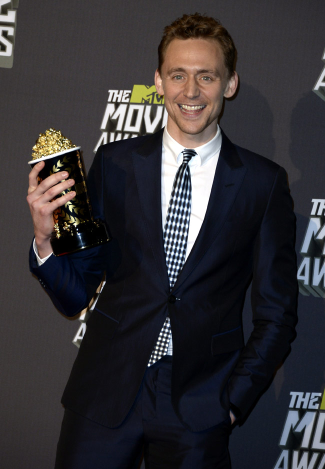 Well-fitting suits and smiles by Tom Hiddleston