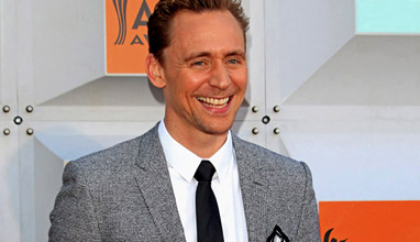 Well-fitting suits and smiles by Tom Hiddleston