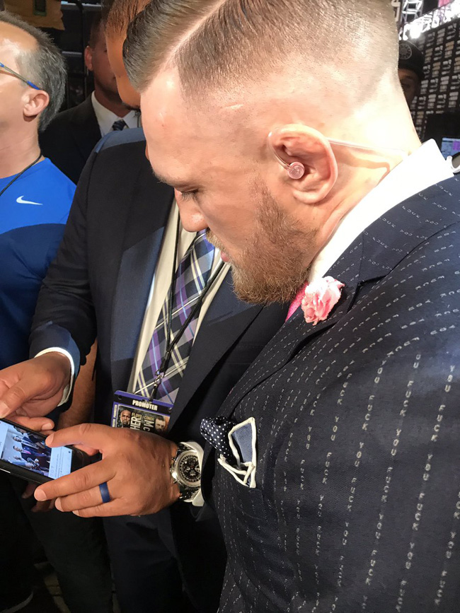 Conor McGregor with a cynical pinstriped suit