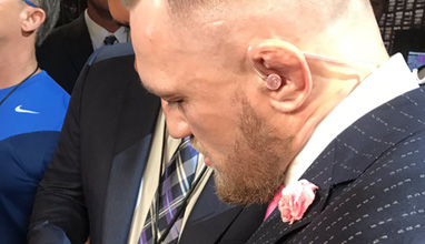 Conor McGregor with a cynical pinstriped suit