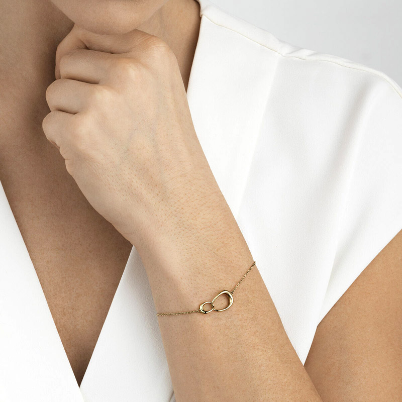 Gold bracelet with a white outfit