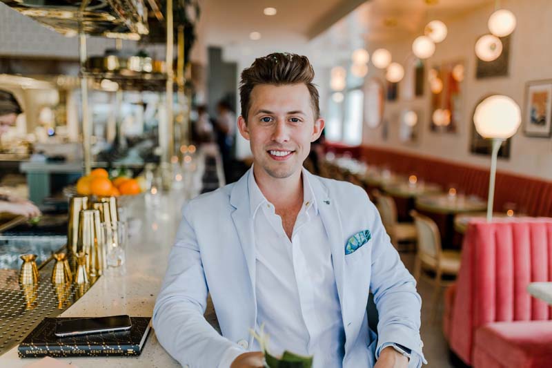 A man in a formal suit in a restaurant